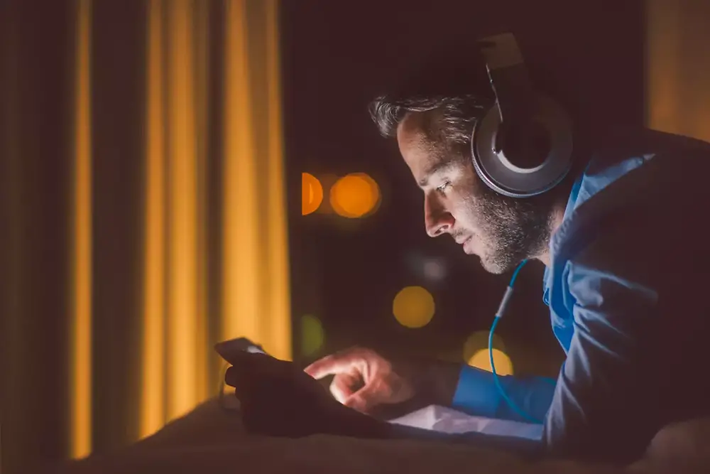 man using a tablet in the evening