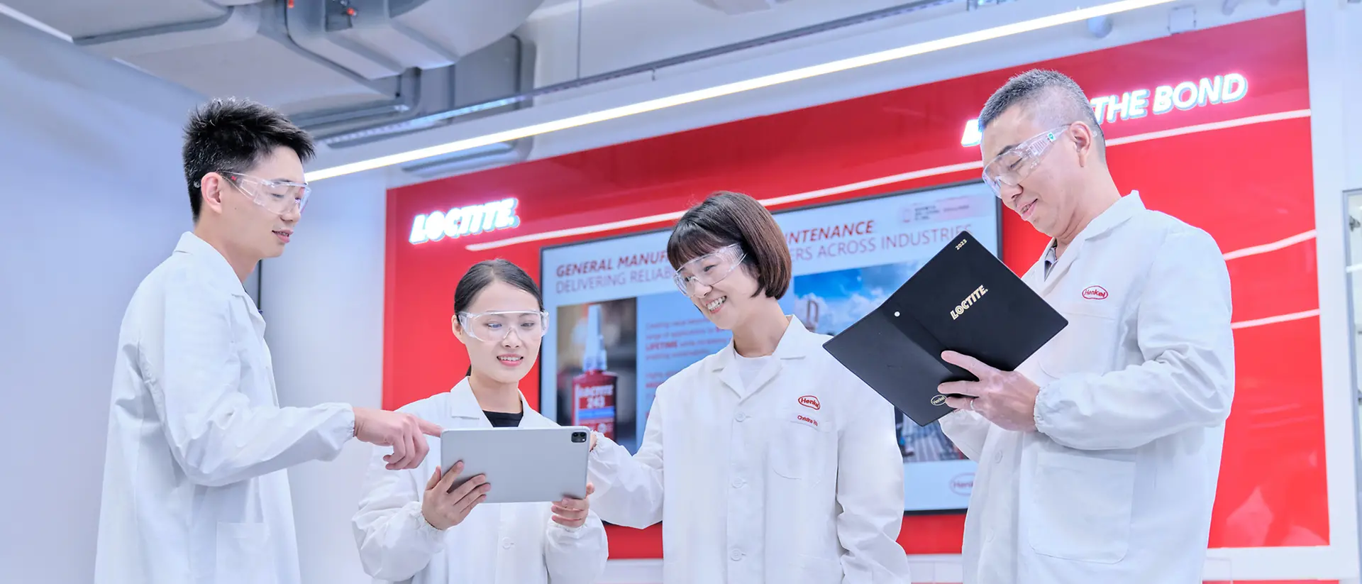 Laboratory technicians discuss test results using a tablet computer