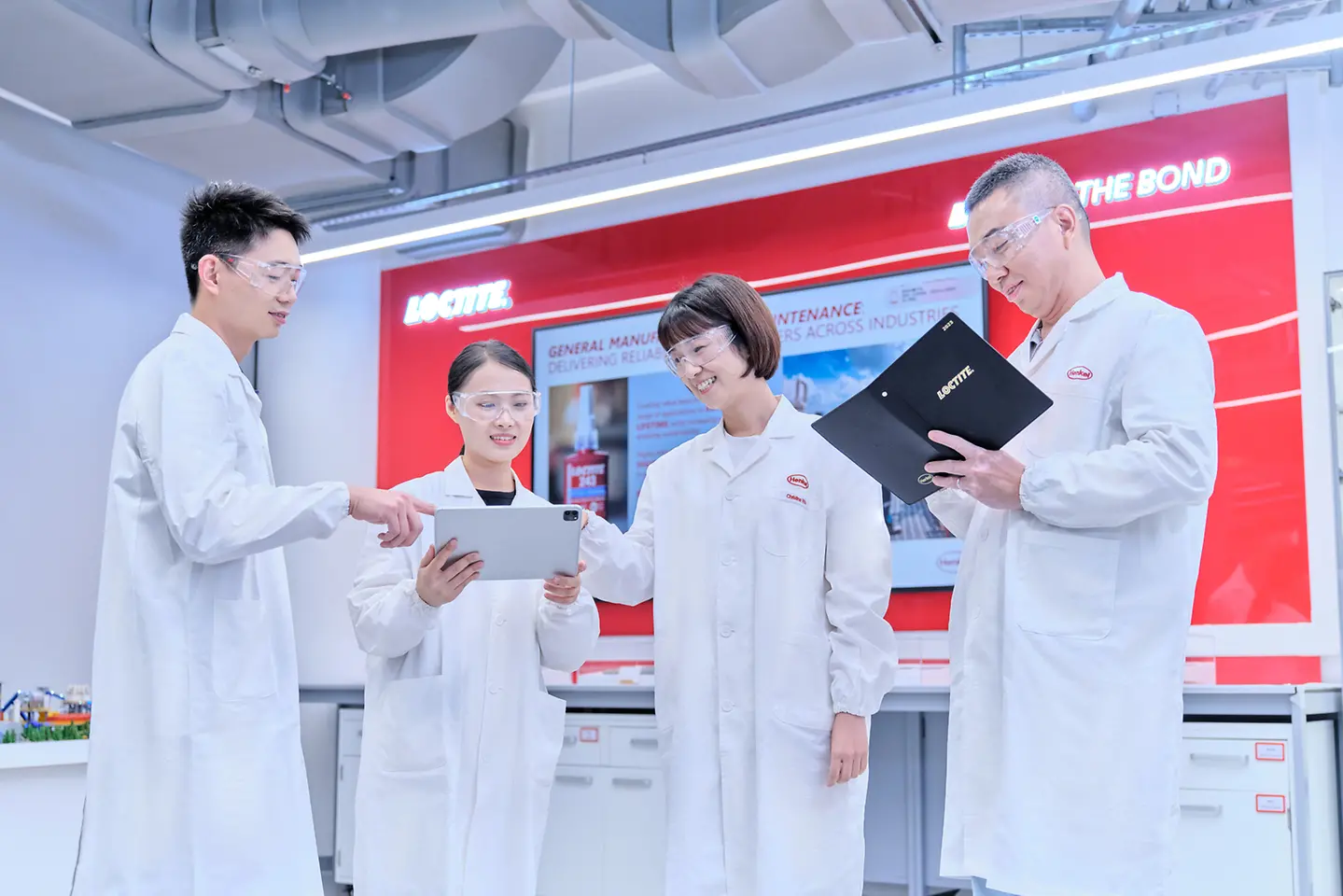 Laboratory technicians discuss test results using a tablet computer